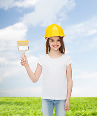 Image showing smiling little girl in helmet with paint brush