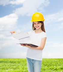 Image showing smiling little girl in hardhat with clipboard