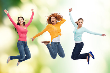 Image showing group of smiling young women jumping in air