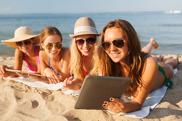 Image showing group of smiling young women with tablets on beach