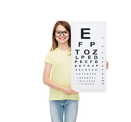 Image showing little girl in eyeglasses with eye checking chart