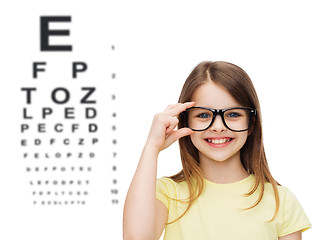 Image showing smiling cute little girl in black eyeglasses