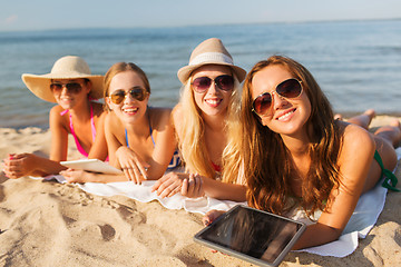 Image showing group of smiling young women with tablets on beach