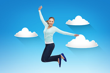 Image showing smiling young woman jumping in air