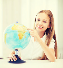 Image showing student girl with globe at school