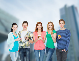 Image showing smiling students with smartphones