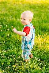 Image showing Little Boy Child Running On Green Meadow