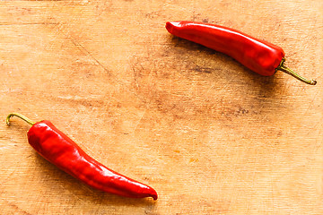 Image showing Red Peppers On Old Wooden Table