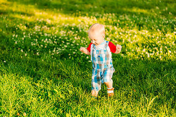 Image showing Little Boy Child Running On Green Meadow