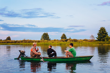 Image showing Belarusian Man And Two Boys Sailing In Old Boat On River At Suns