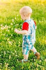 Image showing Little Boy Child Running On Green Meadow