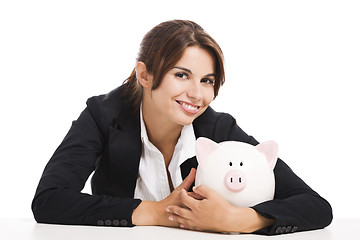 Image showing Businesswoman with a piggy bank