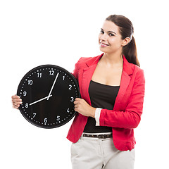 Image showing Business woman holding a clock