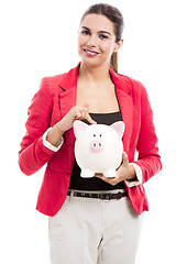 Image showing Business woman with a piggy bank