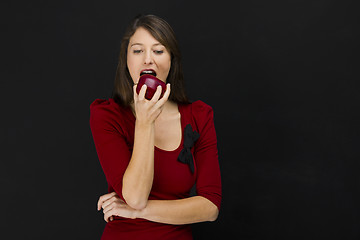 Image showing Young woman eating an apple