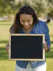 Image showing Beautiful woman holding a shalkboard