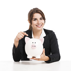 Image showing Businesswoman with a piggy bank