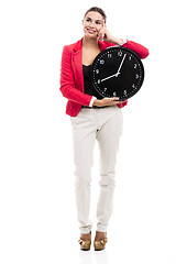 Image showing Business woman holding a clock