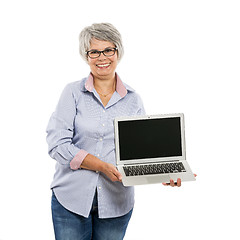 Image showing Elderly woman showing something on a laptop