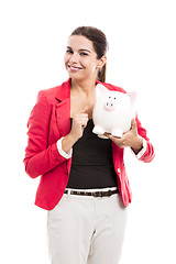 Image showing Business woman with a piggy bank