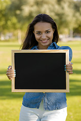 Image showing Beautiful woman holding a shalkboard