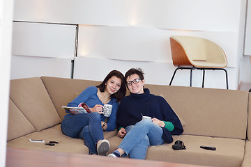 Image showing friends with coffee cups enjoying a conversation