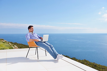 Image showing relaxed young man at home on balcony