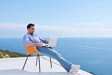 Image showing relaxed young man at home on balcony