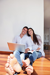 Image showing relaxed young couple working on laptop computer at home