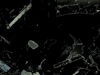 Image showing Shattered glass sharp pieces on black