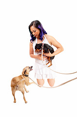 Image showing Woman playing with dog's.