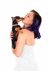 Image showing Woman kissing her dog.