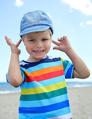 Image showing Small boy holds his hands over ears not to hear