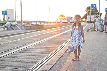 Image showing Lonely girl waiting on a city tram station