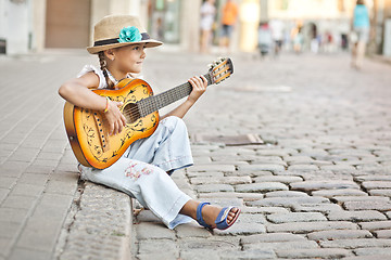 Image showing Girl playing guitar on the street