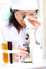 Image showing scientist looking into microscope