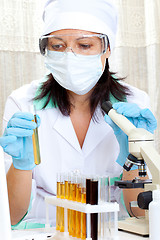 Image showing doctor looking at a test tube of yellow solution