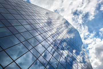 Image showing Skyscraper with reflection of blue sky and clouds