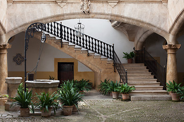 Image showing Cozy european patio with well and stairs