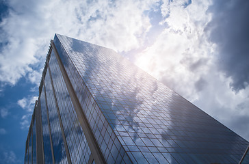 Image showing Skyscraper with reflection of blue sky and clouds