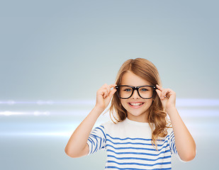 Image showing smiling cute little girl with black eyeglasses