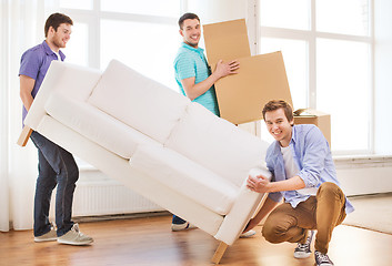 Image showing smiling friends with sofa and cardboard boxes