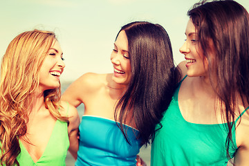 Image showing smiling girls walking on the beach