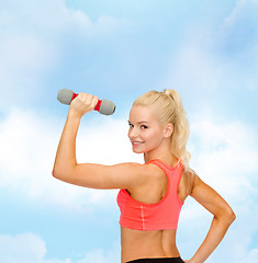 Image showing young sporty woman with light dumbbell