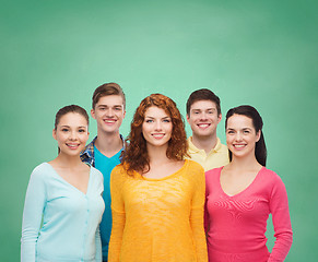 Image showing group of smiling teenagers over green board