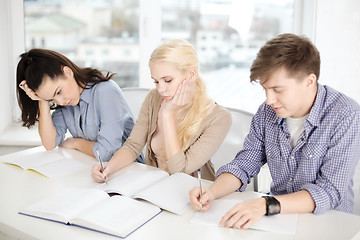 Image showing tired students with notebooks at school