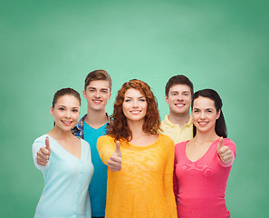 Image showing group of smiling teenagers over green board