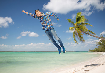 Image showing smiling young man flying in air