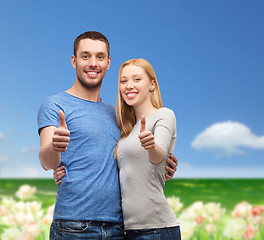 Image showing smiling couple showing thumbs up