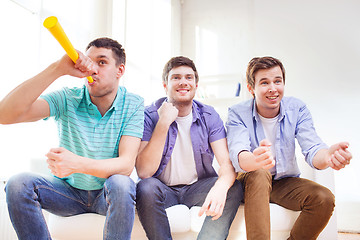 Image showing happy male friends with vuvuzela